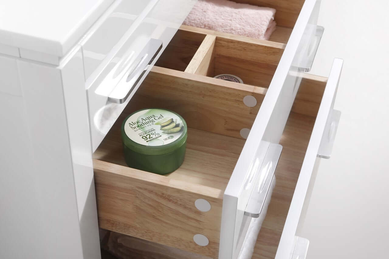 Open drawer of Eiffel 30'' High Gloss White Vanity with neatly organized compartments and a green skincare container